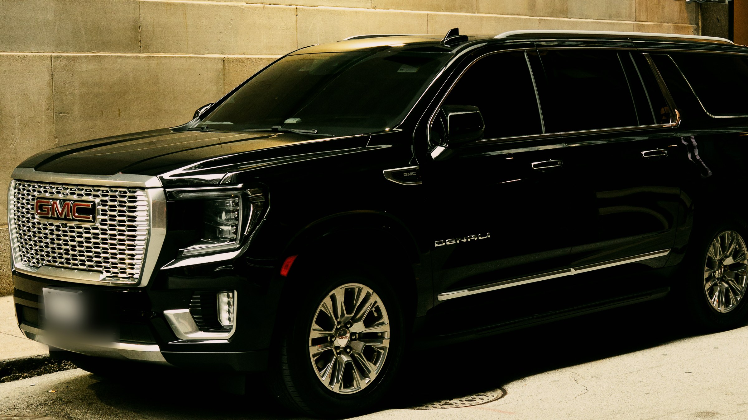 Black GMC Yukon Denali XL curbside at the Union League Club